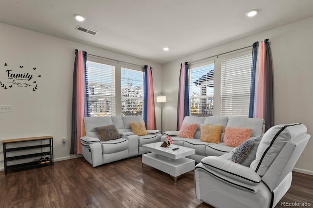 living room featuring plenty of natural light and dark hardwood / wood-style flooring