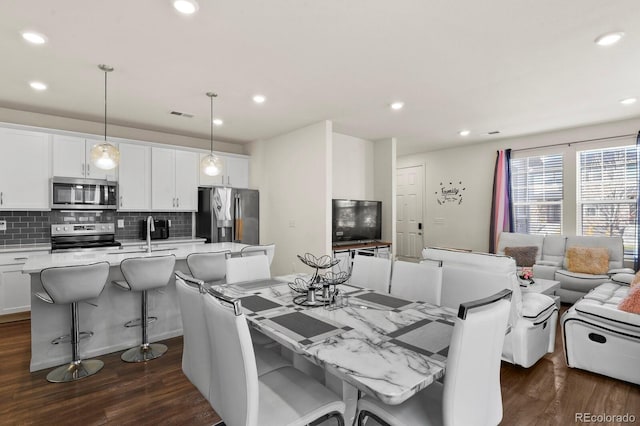 dining room featuring sink and dark hardwood / wood-style floors