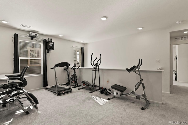 exercise room with light colored carpet