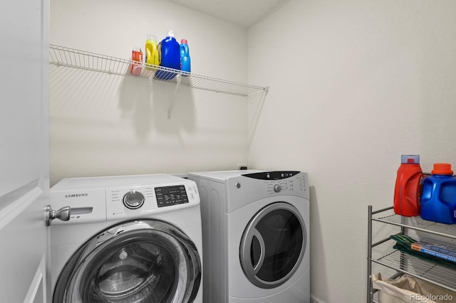 clothes washing area featuring washing machine and clothes dryer