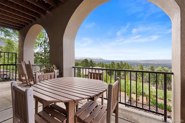948 Manor Gate Pt, Colorado Springs, CO 80906 - balcony featuring a mountain view and outdoor dining space