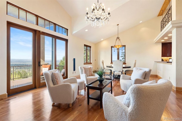 948 Manor Gate Pt, Colorado Springs, CO 80906 - living area featuring a chandelier, high vaulted ceiling, wood finished floors, baseboards, and recessed lighting