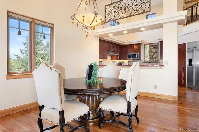 948 Manor Gate Pt, Colorado Springs, CO 80906 - dining space with baseboards, plenty of natural light, light wood-style floors, and recessed lighting