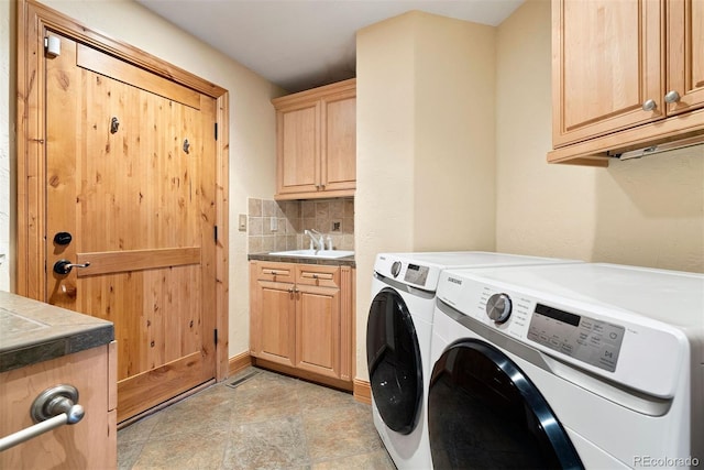 948 Manor Gate Pt, Colorado Springs, CO 80906 - laundry room featuring cabinet space, washing machine and clothes dryer, and light stone finish floors