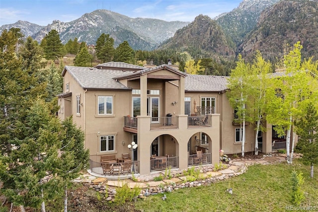 948 Manor Gate Pt, Colorado Springs, CO 80906 - rear view of house featuring a balcony, stucco siding, a mountain view, and a patio area