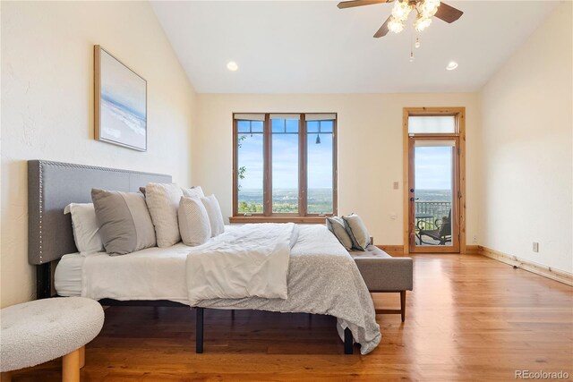 948 Manor Gate Pt, Colorado Springs, CO 80906 - bedroom featuring vaulted ceiling, light wood-style floors, multiple windows, access to exterior, and baseboards