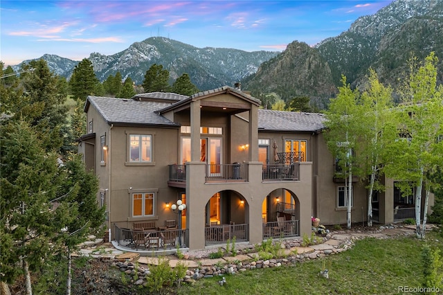 948 Manor Gate Pt, Colorado Springs, CO 80906 - rear view of house featuring a balcony, stucco siding, a mountain view, and a patio area