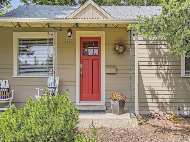 3265 S Ogden St, Englewood, CO 80113 - doorway to property featuring roof with shingles and a porch