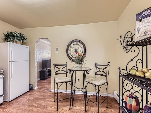 3265 S Ogden St, Englewood, CO 80113 - dining area featuring arched walkways, wood finished floors, and baseboards