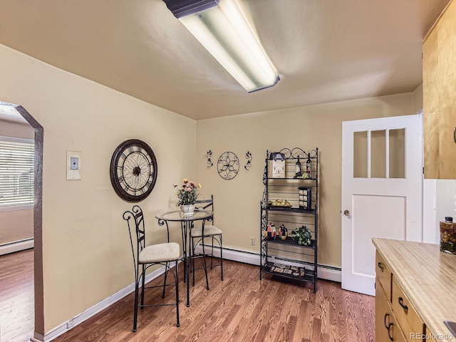 3265 S Ogden St, Englewood, CO 80113 - living area featuring arched walkways, wood finished floors, and baseboard heating