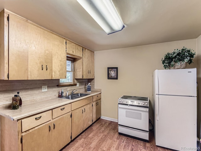 3265 S Ogden St, Englewood, CO 80113 - kitchen with white appliances, a sink, wood finished floors, light countertops, and backsplash