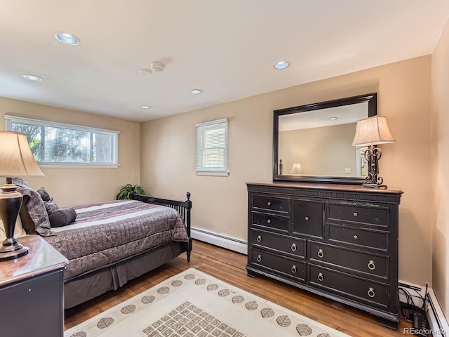 3265 S Ogden St, Englewood, CO 80113 - bedroom featuring a baseboard radiator, wood finished floors, and recessed lighting