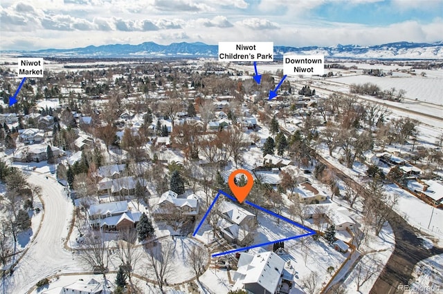 snowy aerial view with a mountain view