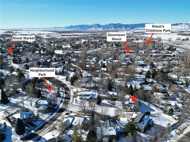 snowy aerial view featuring a mountain view