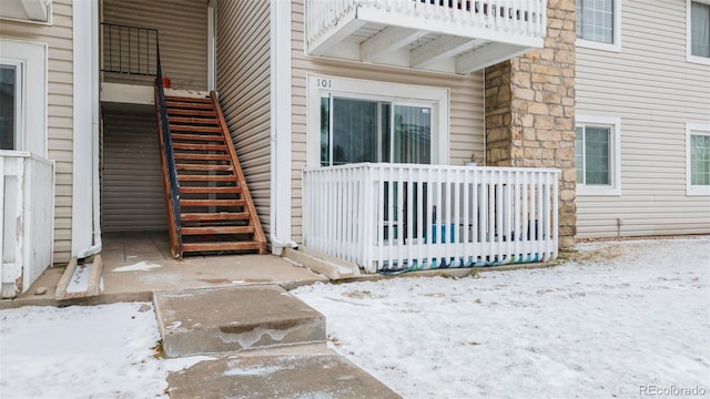 view of snow covered property entrance