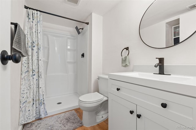 bathroom with vanity, a shower with curtain, toilet, and hardwood / wood-style flooring