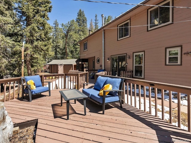 28268 Shadow Mountain Dr, Conifer, CO 80433 - wooden deck featuring an outdoor living space and a storage shed