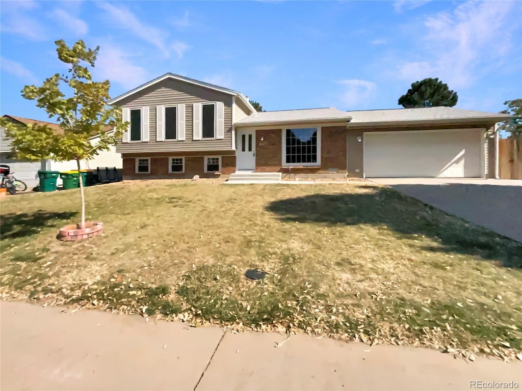 tri-level home with a front yard and a garage