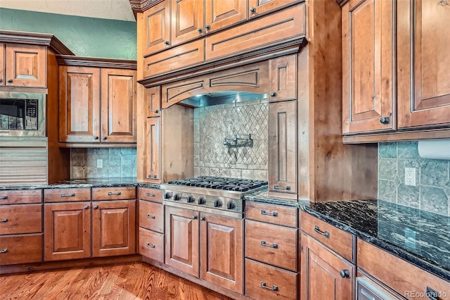4725 Palmer Ridge Dr, Parker, CO 80134 - kitchen featuring backsplash, brown cabinets, and appliances with stainless steel finishes