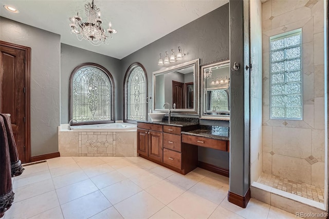 4725 Palmer Ridge Dr, Parker, CO 80134 - bathroom featuring healthy amount of natural light, a garden tub, vanity, a textured wall, and a chandelier