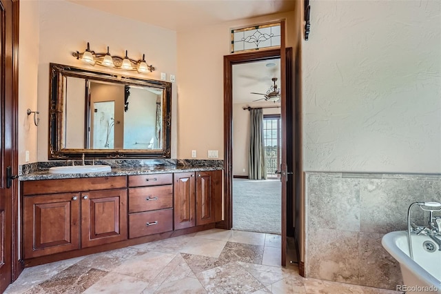 4725 Palmer Ridge Dr, Parker, CO 80134 - full bathroom featuring a freestanding bath, double vanity, and stone finish flooring
