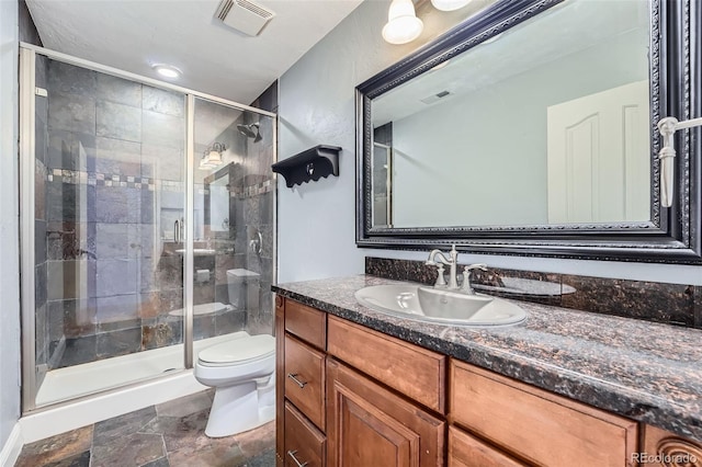 4725 Palmer Ridge Dr, Parker, CO 80134 - bathroom featuring vanity, a stall shower, and stone finish flooring