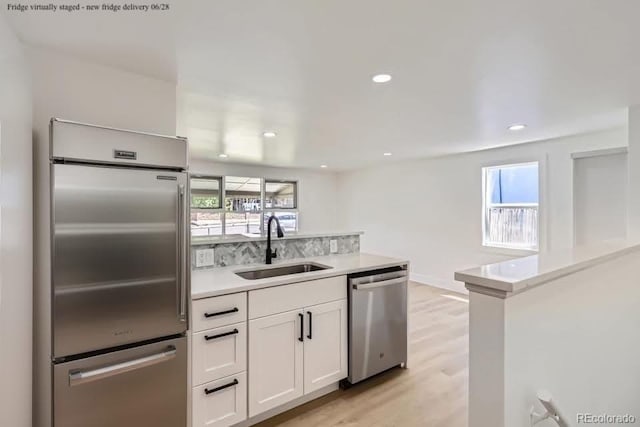 235 S Stuart St, Denver, CO 80219 - kitchen with appliances with stainless steel finishes, healthy amount of natural light, white cabinetry, light countertops, and recessed lighting