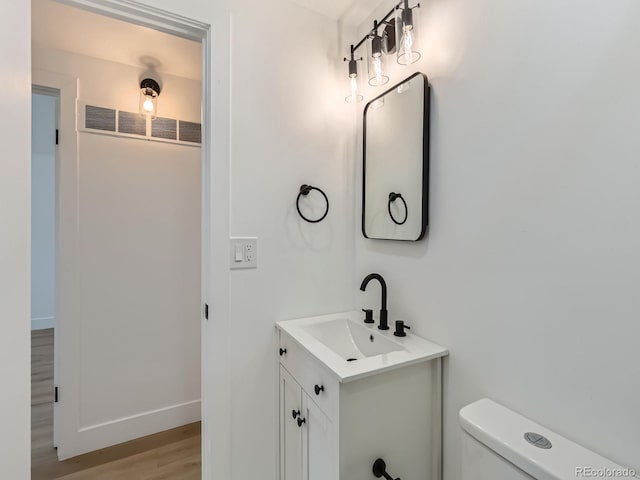 235 S Stuart St, Denver, CO 80219 - bathroom with vanity and wood finished floors