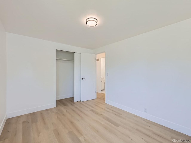 235 S Stuart St, Denver, CO 80219 - unfurnished bedroom featuring light wood-style flooring and a closet