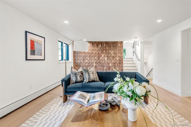 living room featuring recessed lighting, stairway, a baseboard heating unit, wood finished floors, and baseboards