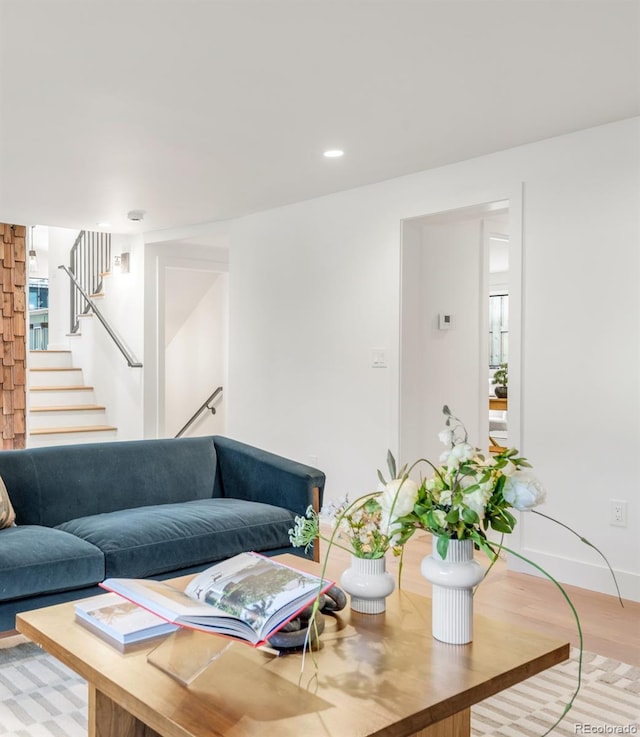 living room with stairs, light wood-style floors, baseboards, and recessed lighting