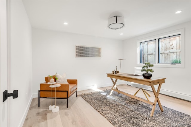 office featuring light wood finished floors, recessed lighting, and baseboards