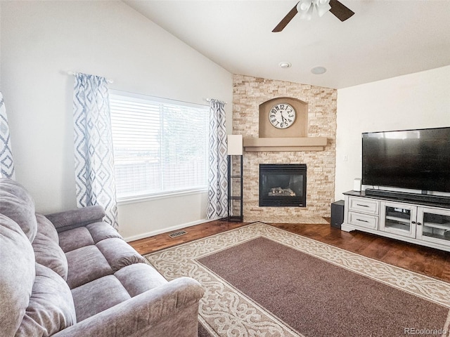 living area with lofted ceiling, dark wood-type flooring, ceiling fan, and a fireplace