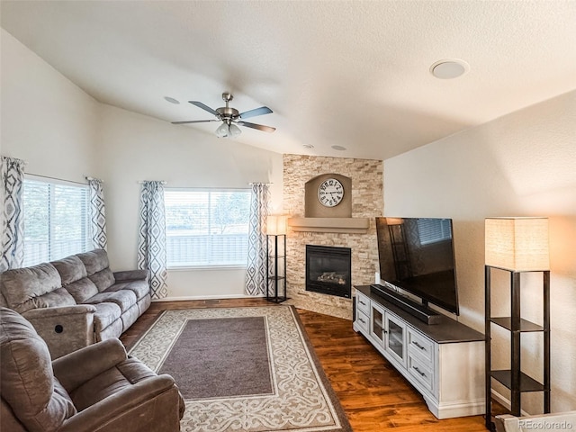 living room featuring a healthy amount of sunlight, ceiling fan, dark wood-style flooring, and vaulted ceiling