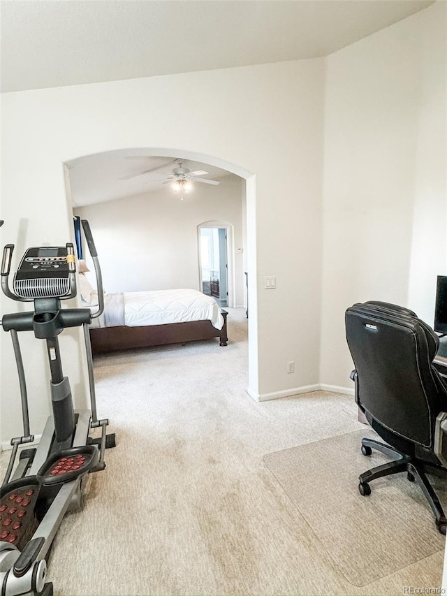 carpeted bedroom featuring baseboards, arched walkways, and vaulted ceiling