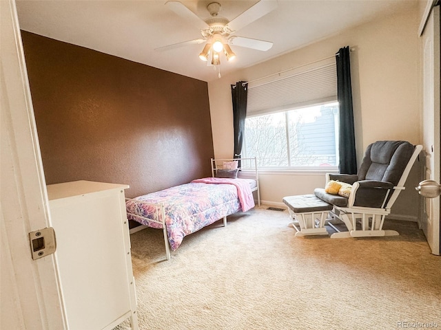 carpeted bedroom with baseboards and ceiling fan