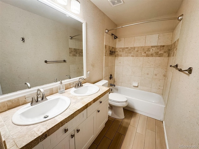 full bath with visible vents, shower / bathing tub combination, wood tiled floor, and a sink