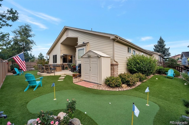 rear view of property with a storage unit, an outdoor structure, a fenced backyard, and a patio area