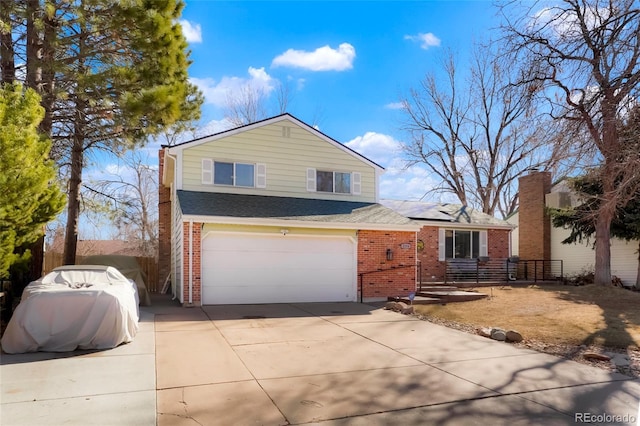 view of front of home featuring brick siding, solar panels, an attached garage, and concrete driveway