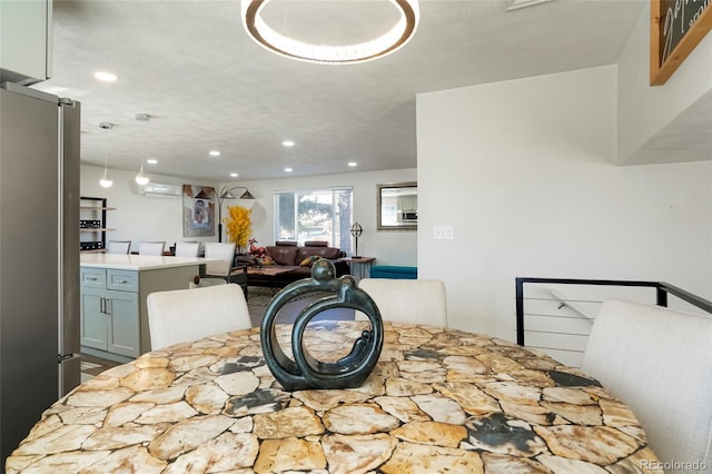 dining space with recessed lighting and an AC wall unit