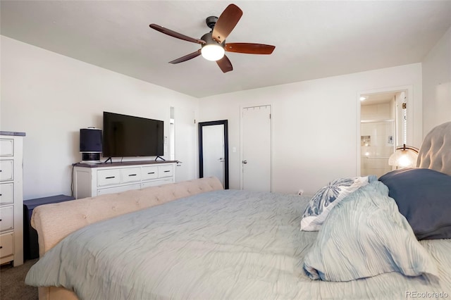 carpeted bedroom featuring ensuite bath and a ceiling fan