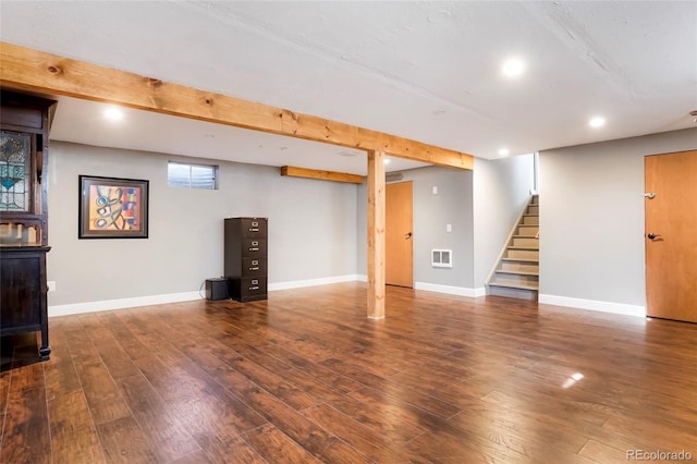 basement with stairway, baseboards, and wood finished floors