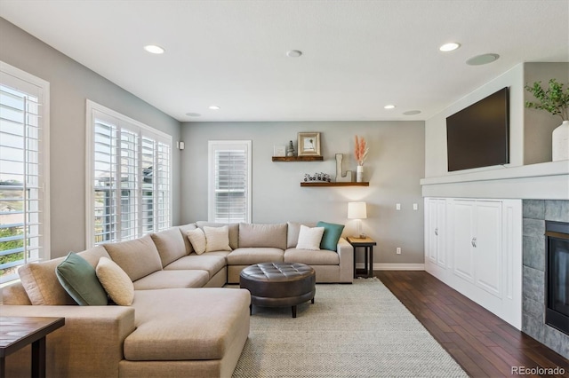 6927 Winter Ridge Pl, Castle Pines, CO 80108 - living area with recessed lighting, a tile fireplace, dark wood-style floors, and plenty of natural light