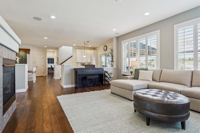6927 Winter Ridge Pl, Castle Pines, CO 80108 - living room with a fireplace, baseboards, dark wood-style floors, and recessed lighting