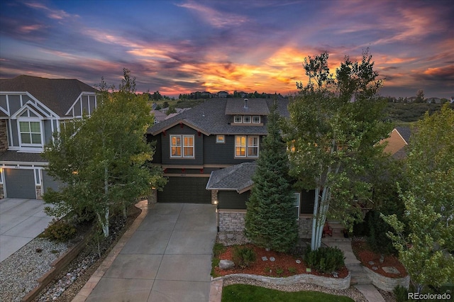 6927 Winter Ridge Pl, Castle Pines, CO 80108 - view of front of home featuring a garage, a shingled roof, stone siding, and concrete driveway