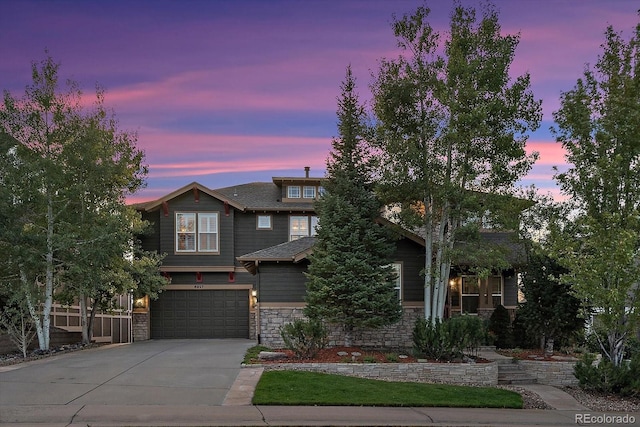 6927 Winter Ridge Pl, Castle Pines, CO 80108 - view of front of house featuring stone siding, an attached garage, and concrete driveway