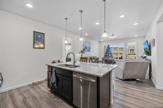 kitchen with light stone counters, a kitchen island with sink, sink, light hardwood / wood-style flooring, and dishwasher