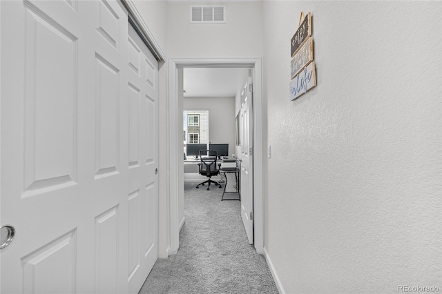 corridor with light carpet