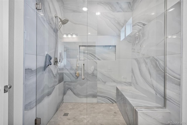 bathroom with a shower with door