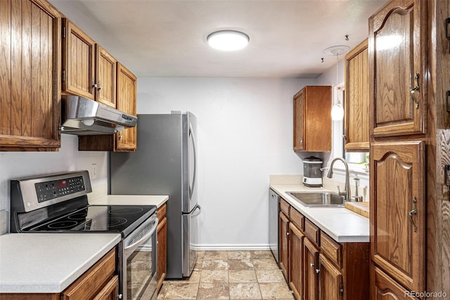 11886 Birch Dr, Thornton, CO 80233 - kitchen with under cabinet range hood, appliances with stainless steel finishes, a sink, baseboards, and brown cabinets